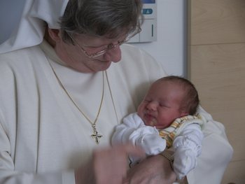Ordensfrau mit Baby im Arm